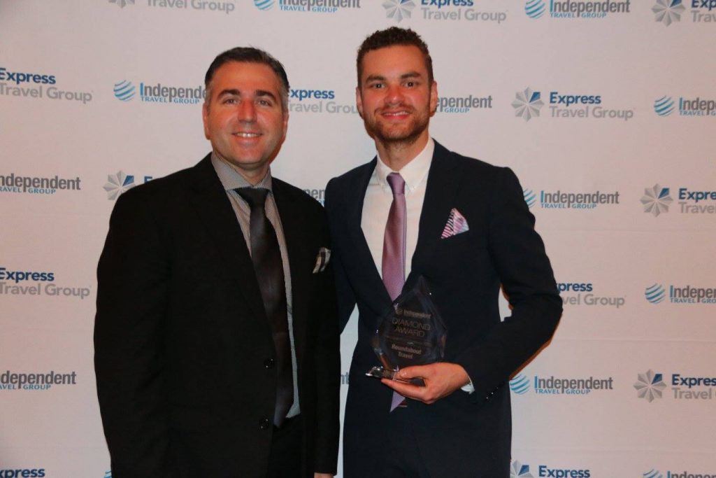 RoundAbout Travel Awarded National Agent of the Year. Company Director Mark Trim accepting the award on behalf of RoundAbout Travel from Ari Magoutis, Executive General Manager for the Independent Travel Group and Express Travel Group.