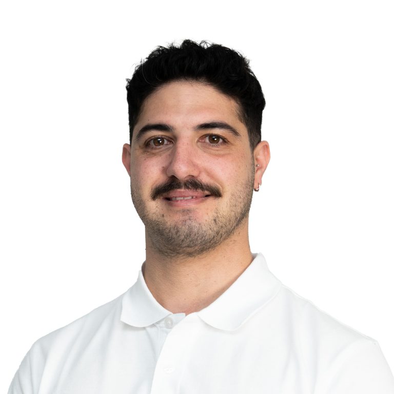 Close-up of a man's lower face showing mustache and stubble, wearing a white collared shirt